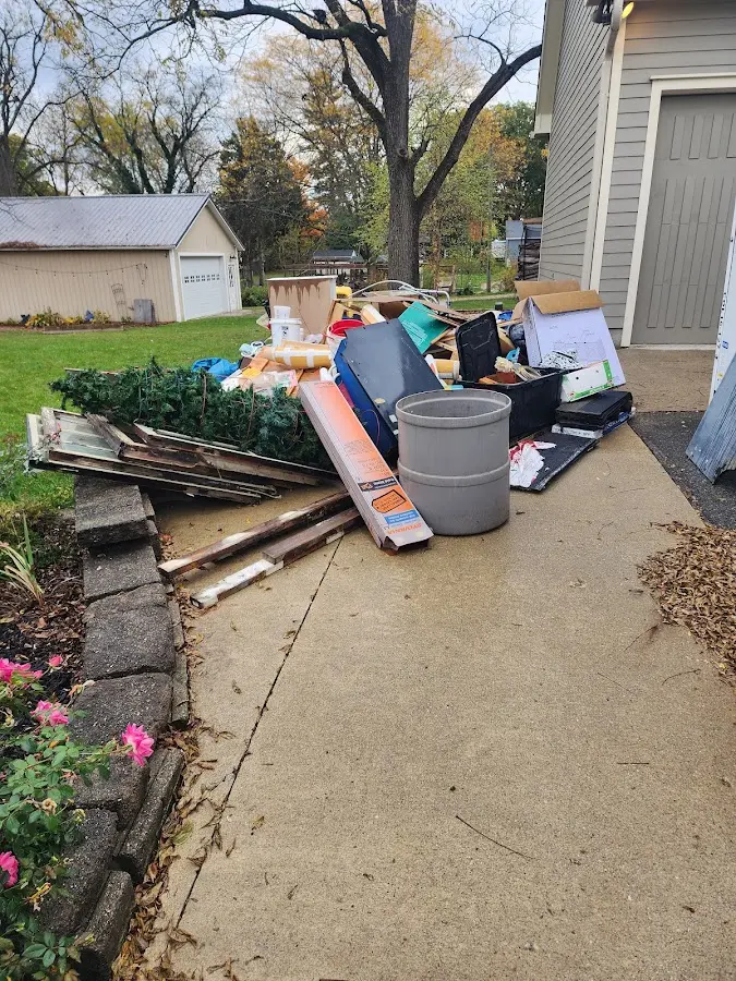 Dumpster being loaded with debris for Roofing Dumpster Rental in Union Mill